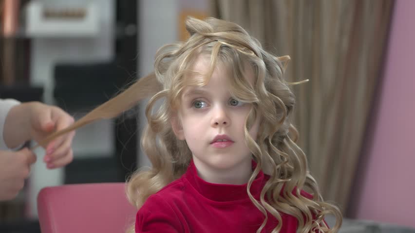 Little Girl With Curly Hair Kid At The Hairdresser