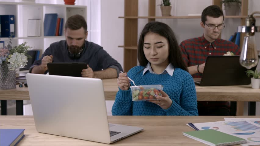 Businesswoman Eating Lunch At Her Desk In Her Office Stock Footage ...