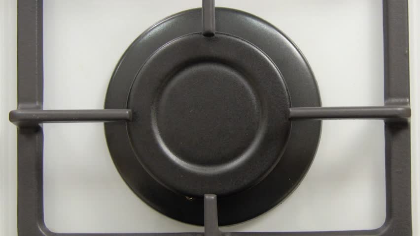Natural gas inflammation in stove burner, close up view.
gas burning from a kitchen gas stove