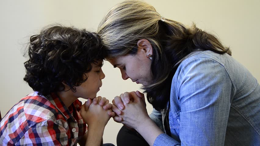 Hispanic Mother Educating And Guiding Her Child Son Into Christianity ...