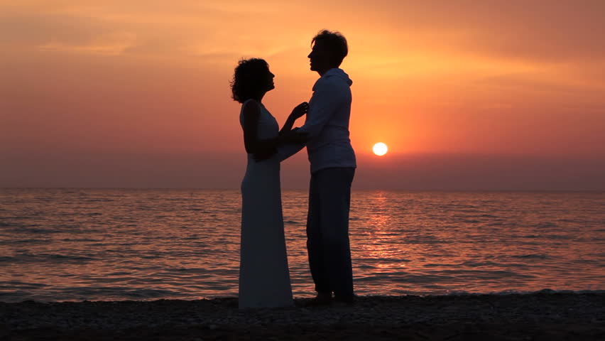 Bride & Groom In Silhouette Dancing At Sunset On The Beach After Their ...