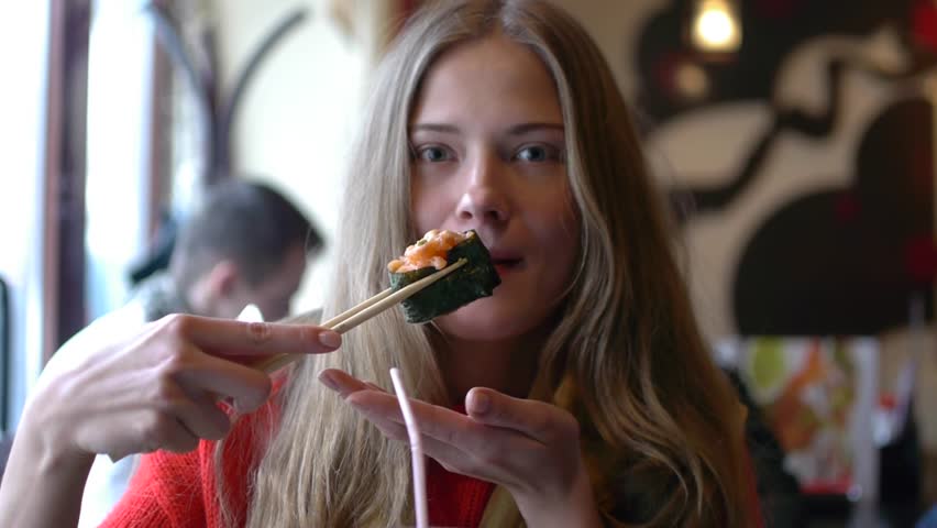 HD1080p25 Sexy woman eating sushi in restaurant and enjoying.