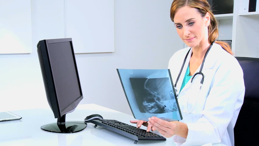 Female Caucasian Hospital Doctor Using Computer Monitor To -7085