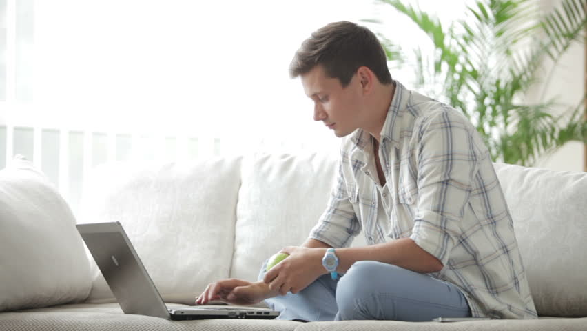 Good-looking Guy Sitting On Sofa Video de stock (totalmente libre ...