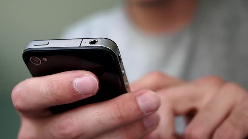 Young man using his iPhone