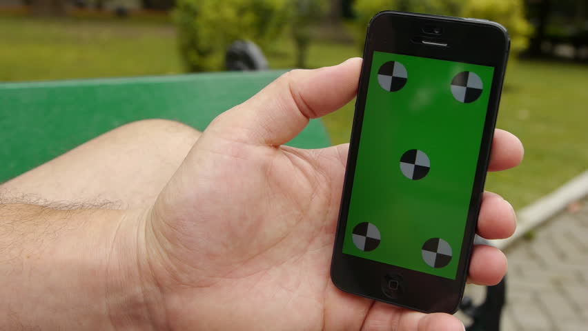 Using A Smart Phoneheld By Stock Footage 100 Royalty Free Using A Smart Phoneheld By Hands While Sitting At The Park Green Screen Chroma Key Close Up Tracking Motion Vertical Tile Floor Grass