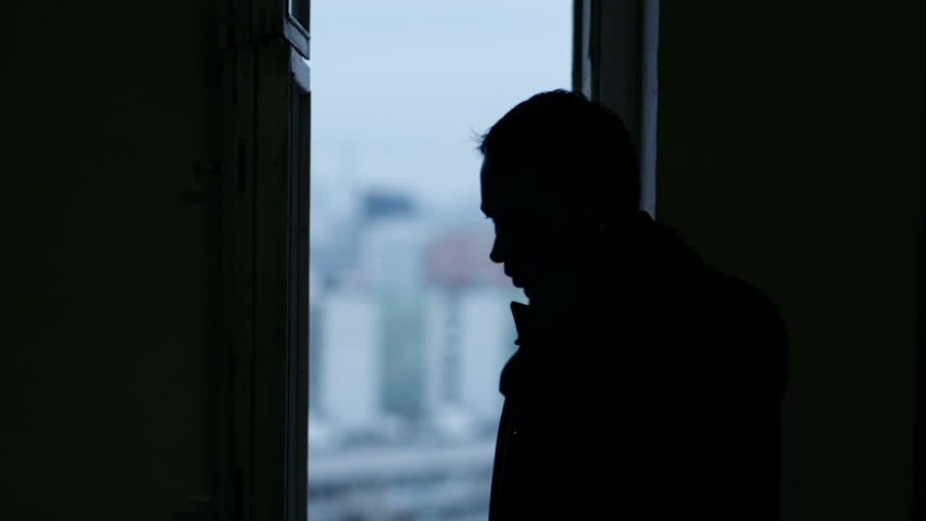 Silhouette Of Stylish Man In Suit Looking Out The Window 