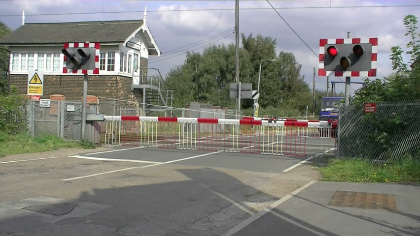 Diesel Train Crossing A Level Crossing Then The Barrier Goes Up. Stock ...