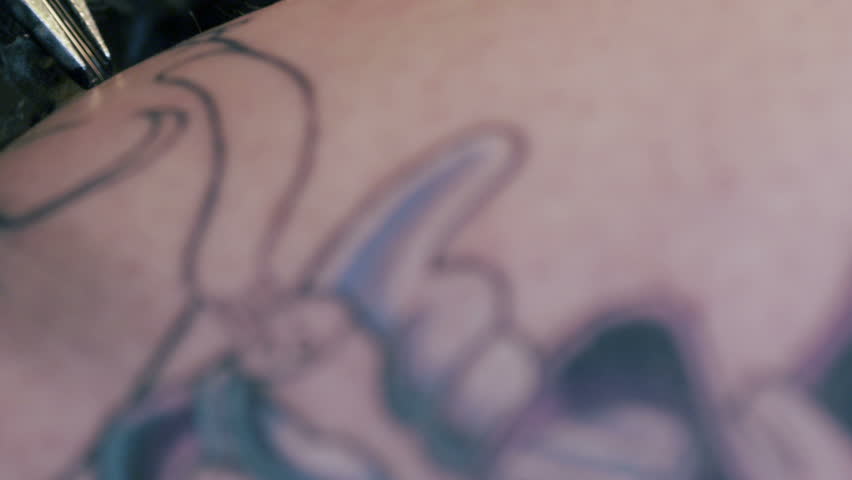 tattoo artist close up shot of tattoo gun drawing on person u0027s tattoo artist close up shot of tattoo gun drawing on person u0027s