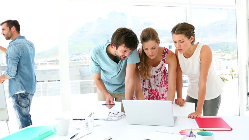 Colleagues Having A Meeting Looking At Whiteboard In Creative Office ...