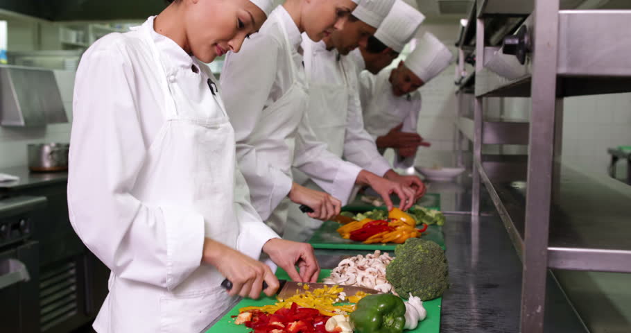 Busy Kitchen chefs at work in a busy kitchen in a commercial kitchen stock Busy Kitchen chefs at work in a busy kitchen in a commercial kitchen stock