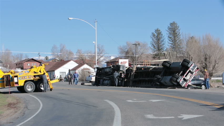 MORONI, UTAH - MAR 2014: Accident Truck Trailer Rollover Tow Truck