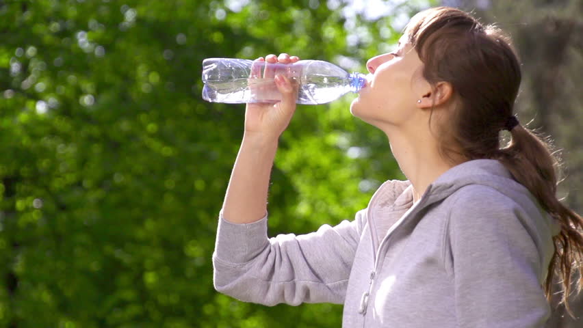 Young Girl Drinking Water Out Of A Plastic Bottle Outside Stock Footage ...