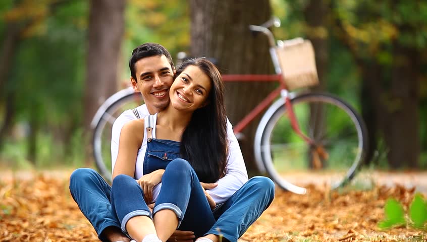 Teen Couple With Retro Bike Kissing In The Park In Autu