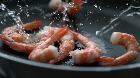 Shrimp splashing into hot oil in frying pan, slow motion; shot on Phantom Flex 4K at 1000 fps