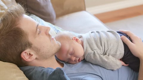 baby sleeping on dads chest