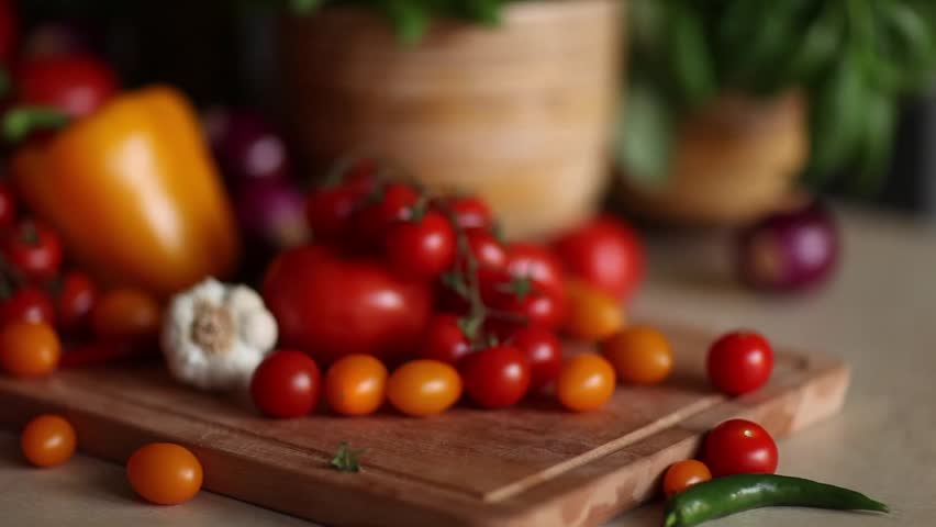 Kitchen Table With Food cutting tomato and preparing slice of bread on grey kitchen table Kitchen Table With Food cutting tomato and preparing slice of bread on grey kitchen table