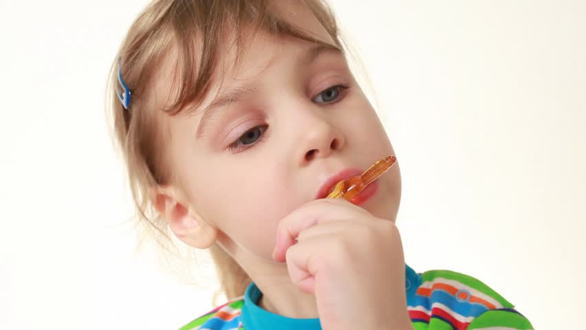 Little Girl Licking Orange Lollipop Stock Footage Video -1228